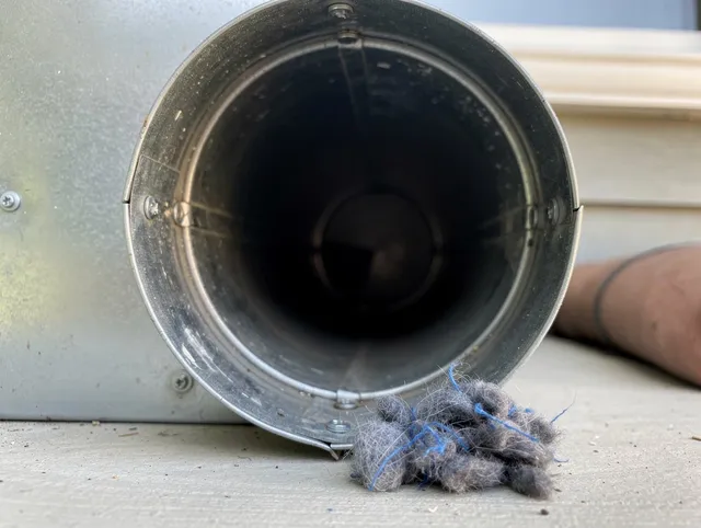 North Miami Dryer Vent Cleaning technician using specialized equipment to clear severe dryer vent blockage in North Miami